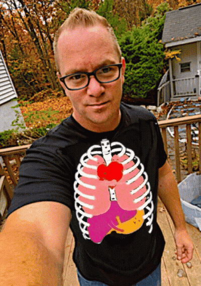 Man In Black T-Shirt With Skeleton Ribs And Heart GIF