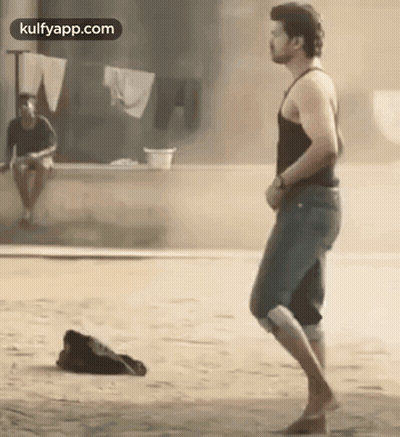 Man in Black Tank Top and Blue Shorts