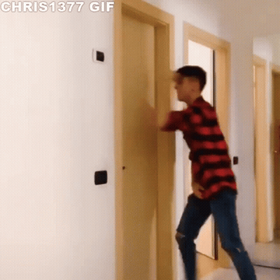Man In Black Tank Top And Red Shorts In Bathroom GIF