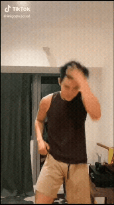Man In Black Tank Top Dancing In Living Room GIF