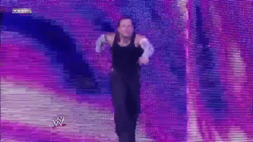 Man In Black Tank Top Dancing On Stage With W Logo GIF