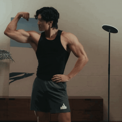 Man In Black Tank Top Flexing Arm GIF
