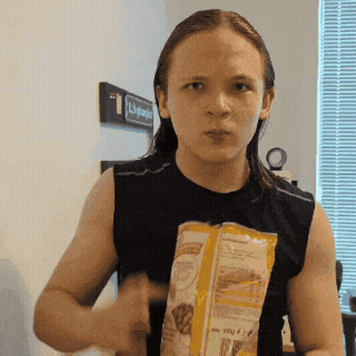 Man In Black Tank Top Holding Food Bag GIF