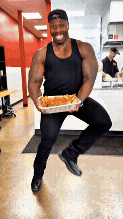 Man In Black Tank Top Holding Food Container GIF