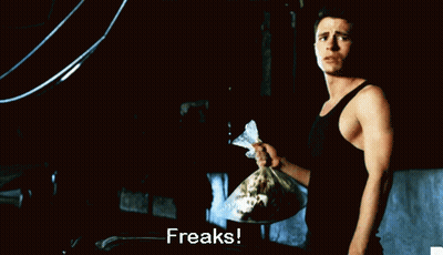 Man In Black Tank Top Holding Freaks Bag GIF