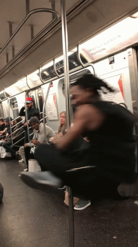 Man In Black Tank Top Riding Subway Train GIF