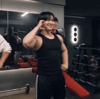 Man In Black Tank Top Smiling In Gym GIF