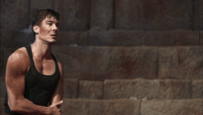 Man In Black Tank Top Standing Before Mountain GIF