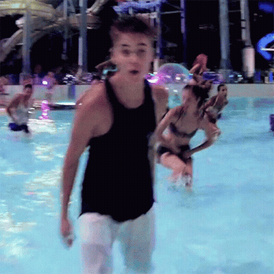Man In Black Tank Top Standing In Water GIF