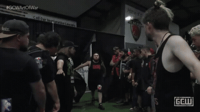 Man In Black Tank Top With Red GCW Logo GIF