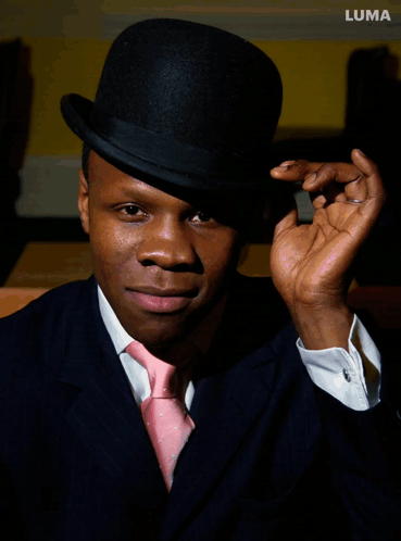 Man In Black Top Hat And Pink Tie With Luma GIF