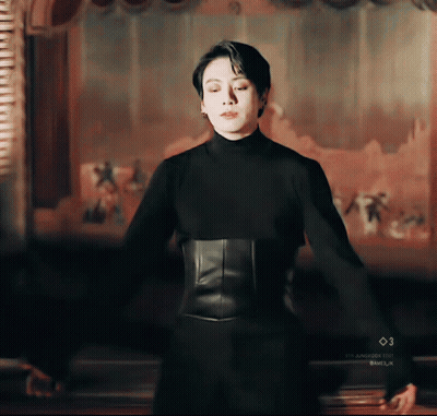 Man In Black Turtleneck And Corset GIF