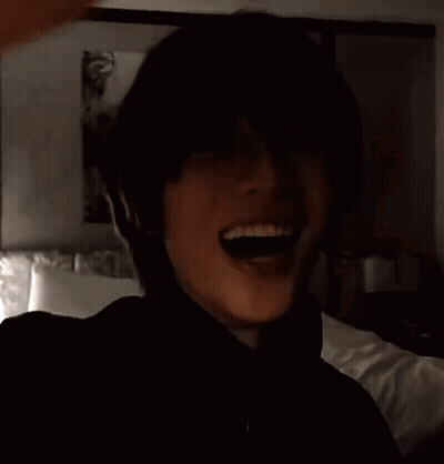 Man In Black Turtleneck In Front Of Bed GIF