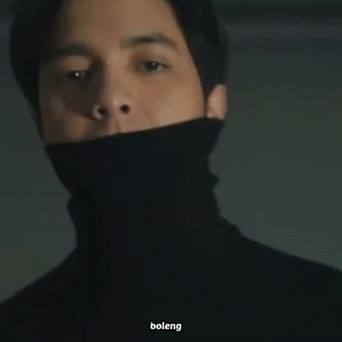 Man In Black Turtleneck Looking At Camera GIF