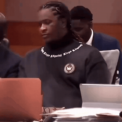 Man In Black Turtleneck With Atripa On Neck GIF