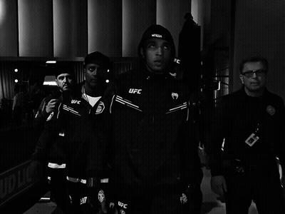 Man In Black UFC Jacket Walking With Security Guard GIF