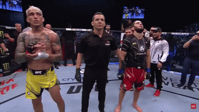 Man In Black UFC Shirt Holding Arm Up GIF