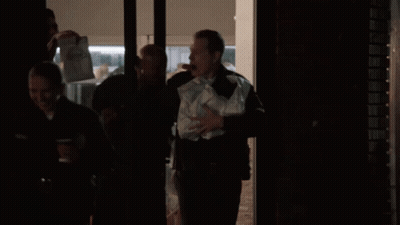 Man In Black Uniform Holding Bag Of Papers GIF
