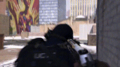 Man In Black Uniform Holding Gun In Front Of Graffiti Building GIF