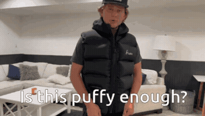 Man in Black Vest Saying Is This Puffy Enough