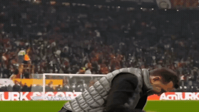 Man In Black Vest Walking On Soccer Field GIF