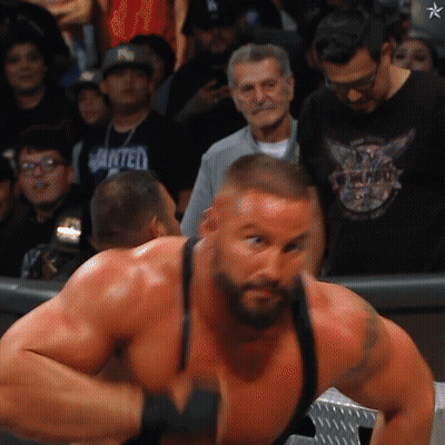 Man In Black Wanted Shirt Facing Crowd GIF