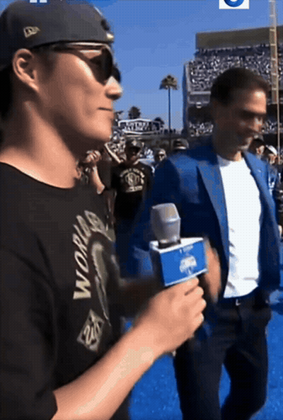 Man In Black World Shirt Holding Microphone GIF