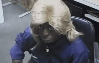 Man In Blonde Wig And Blue Falcon Shirt GIF