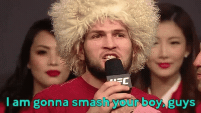 Man In Blonde Wig Holding Microphone Says I Am Gonna Smash Your Boy Guys GIF