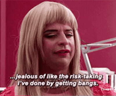 Man In Blonde Wig Talking About Bangs GIF