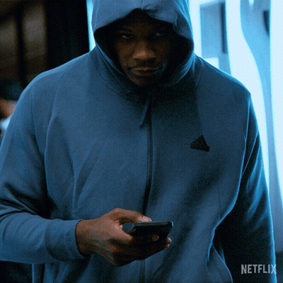 Man In Blue Adidas Hoodie Looking At Phone GIF