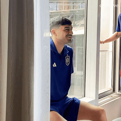 Man In Blue Adidas Shirt Sitting By Window GIF