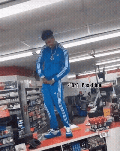 Man In Blue Adidas Tracksuit Standing In Store GIF