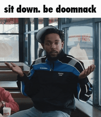 Man In Blue And Black Jacket Sitting GIF