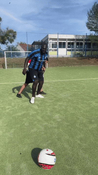 Man In Blue And Black Jersey Kicking Ball GIF