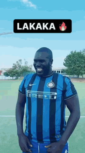 Man In Blue And Black Striped Shirt Hands On Hips Soccer Field GIF