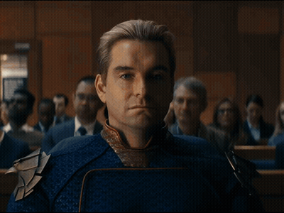 Man In Blue And Gold Costume Sitting In Room GIF