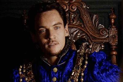 Man In Blue And Gold Costume Sitting In Wooden Chair GIF