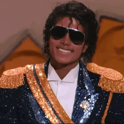 Man In Blue And Gold Jacket Saying Hello Chat GIF
