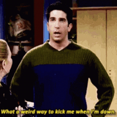 Man In Blue And Green Sweater Talking To Woman GIF