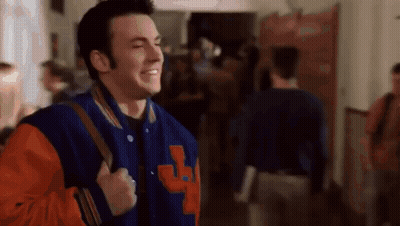 Man In Blue And Orange Varsity Jacket Walking With Backpack GIF