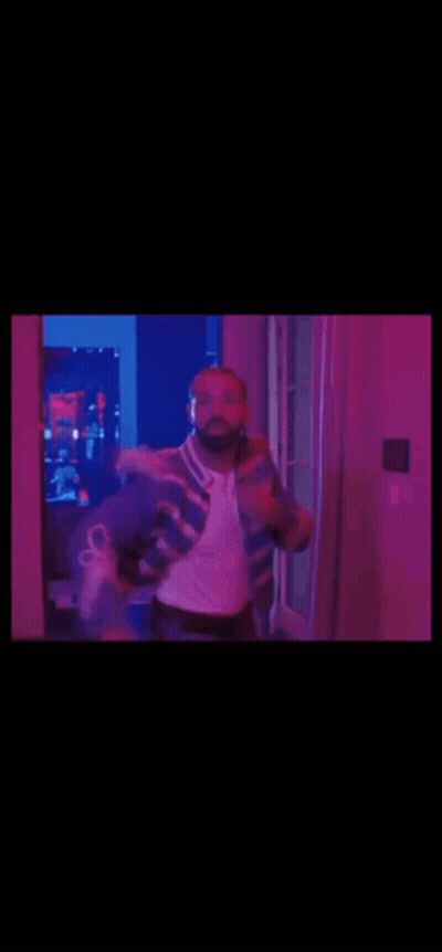 Man In Blue And White Jacket Dancing In Purple Lights GIF