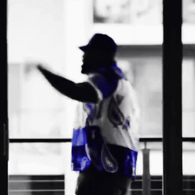 Man In Blue And White Jersey Waving By Window GIF