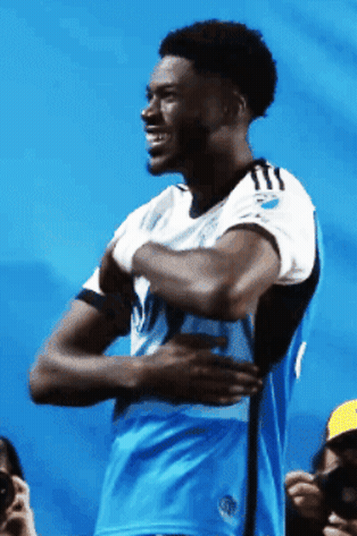 Man In Blue And White Jersey With Letter T GIF