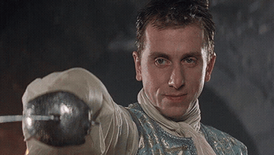 Man In Blue And White Outfit Holding Sword GIF