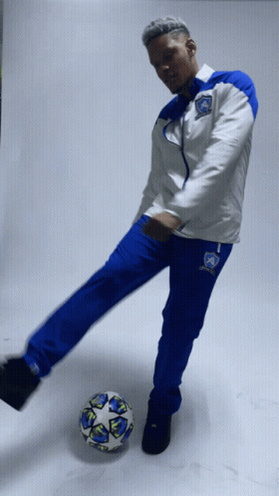 Man In Blue And White Soccer Uniform Kicking Ball GIF