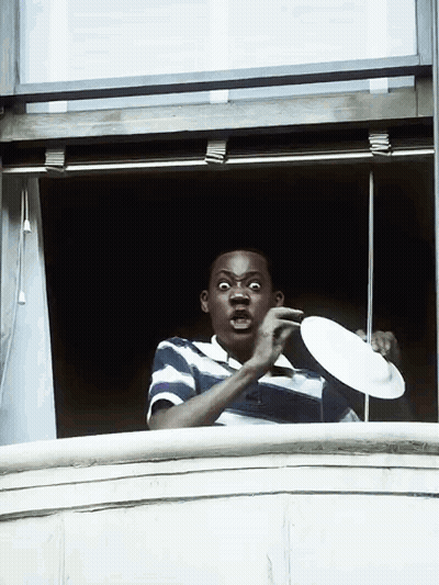 Man In Blue And White Striped Shirt Holding Plate GIF