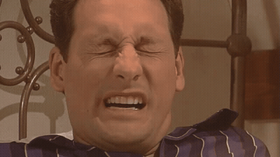 Man In Blue And White Striped Shirt Making Funny Face GIF