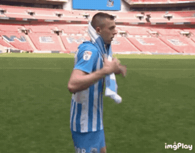 Man In Blue And White Striped Shirt Running On Soccer Field With Towel GIF