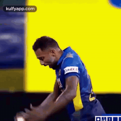 Man In Blue And Yellow Jersey Standing On Field GIF